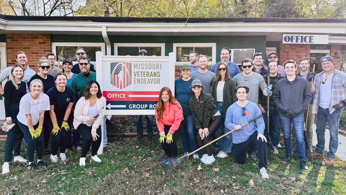 Group of volunteers posing in front of the office
