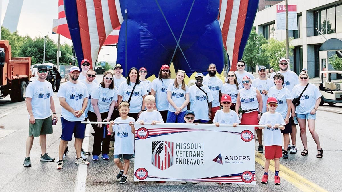 Group of volunteers at parade with giant inflatable eagle.