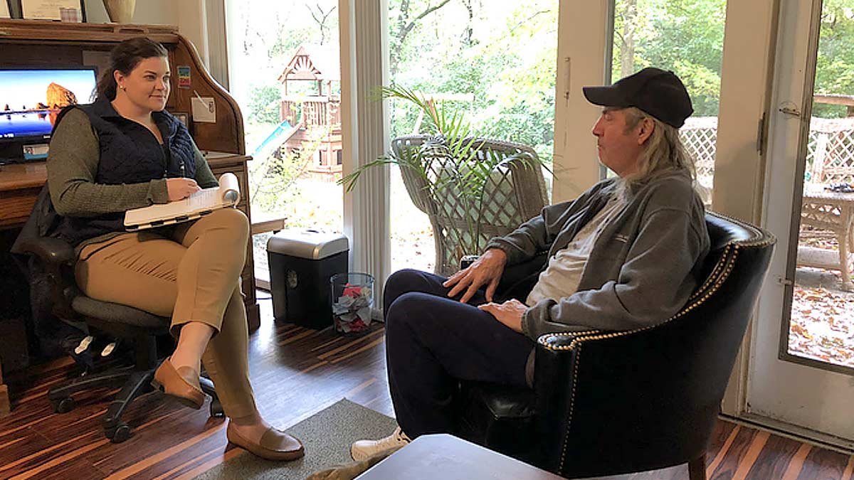 Therapist and vet talking in office