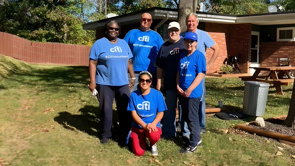 Group of volunteers doing yard work at the residence
